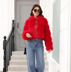 Detail of premium red faux fur jacket texture with full-zip and stand collar design