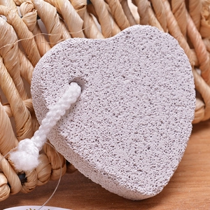 Macro shot of heart-shaped volcanic pumice stone for callus removal with natural rope