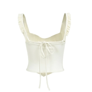 Detail view of cream cropped camisole featuring ruffle straps and tie-back closure