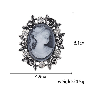 Vintage silver cameo brooch with rose accents and sparkling rhinestones for coats