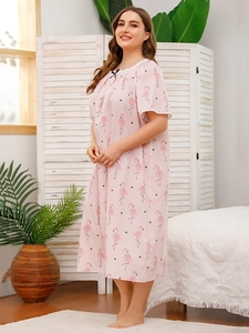 Close-up of pink flamingo nightgown featuring delicate lace trim and a small black bow