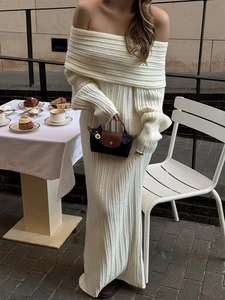 Close-up of white ribbed knit fabric texture and elegant off-shoulder fold detail
