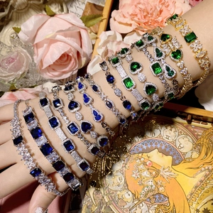 Detailed view of layered gemstone bracelets with gold and silver plating on wrist