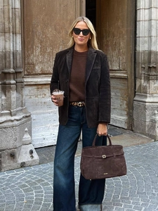 Women brown faux suede buttoned blazer with wide-leg denim jeans street style