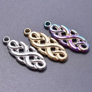 Macro view of Celtic witch knot pendants in silver, gold, and iridescent finishes