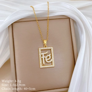 Detail of gold hollow square Fe pendant with rhinestones on luxury silk background