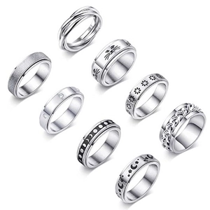 Detail view showing eight diverse spinner stress relief rings with celestial and moon motifs