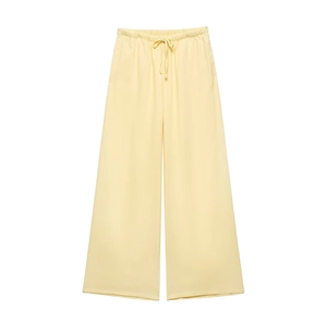 Detail of pale yellow wide-leg trousers with drawstring elastic waist for casual wear