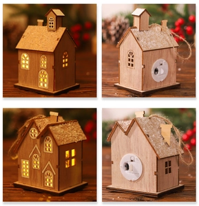 Detail of LED wooden Christmas house ornaments with faux snow and hanging ropes