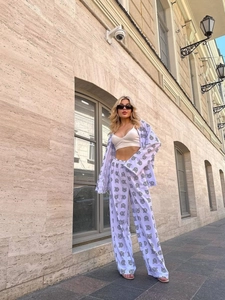 Chic white two-piece set with black owl print featuring long sleeve top and wide leg pants