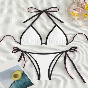Two-piece contrast bikini set with halter top and side-tie bottoms in white and black