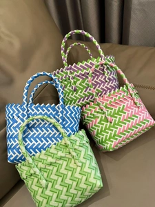 Detail of colorful plastic woven baskets in green blue purple and pink colors