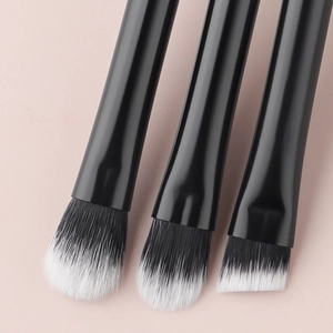 Detail of 3 mini makeup brushes with crystal handles and black-white gradient bristles