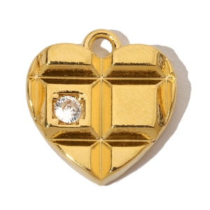 Detail of gold heart pendant featuring a grid texture and a centered sparkling zircon