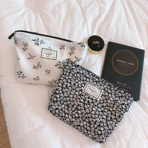Floral puffy cotton hand bags with black and white rose patterns and zipper closure