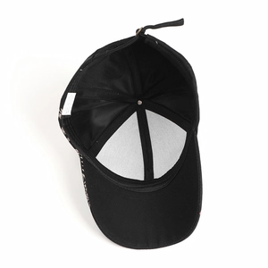 Interior detail of a 100% cotton black baseball cap showing the six-panel sewing structure