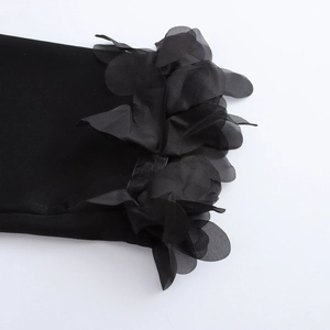 Elegant black V-neck long sleeve blouse featuring 3D floral accents on the cuffs and hem