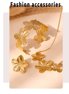 Detailed view of textured gold flower necklace and bracelet set on a soft beige surface