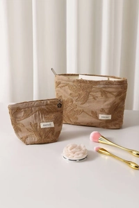 Detail of floral embroidery on beige linen cosmetic bags with two size options