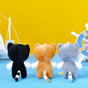 Back view of three cute plush cat keychains in black, orange, and gray color variants