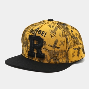 Close-up of 3D letter R embroidery on yellow canvas snapback hip hop hat with graffiti