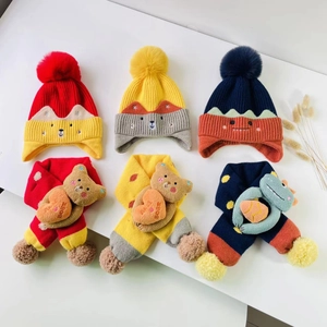 Detail of knitted children's hat and scarf sets with cute cartoon animal decorations