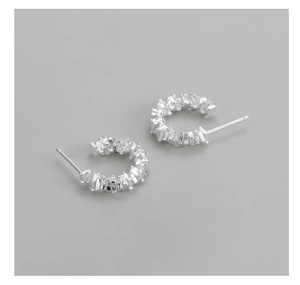 Detailed view of S925 sterling silver earrings with textured crushed silver finish