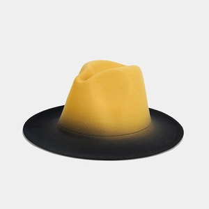Detailed view of yellow and black gradient wool felt jazz hat with flat brim and smooth texture
