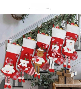 Detail of five assorted plush Christmas stockings with Santa, reindeer, and snowman dolls