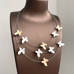 Three-layer butterfly pendant necklace with gold and silver brushed metal charms