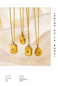 Macro detail of gold starburst necklaces with zircon stones on soft silk fabric