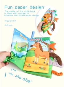 Close-up of soft baby cloth book with 3D animal tails and crinkle paper for sensory play