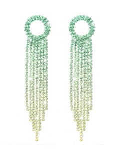 Close-up of long tassel earrings with green to yellow gradient rhinestones and crystals