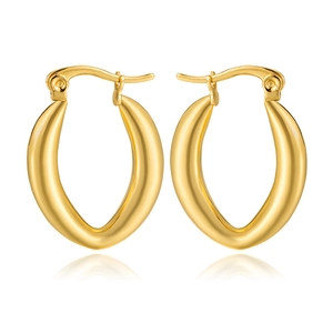 Macro shot of polished gold-plated stainless steel hollow C-shape earrings with reflections