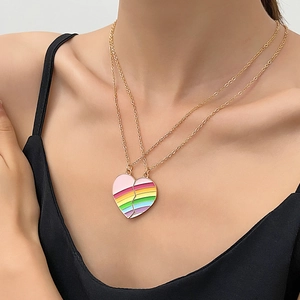 Detail of friendship necklace set with interlocking rainbow heart pendants in gold finish