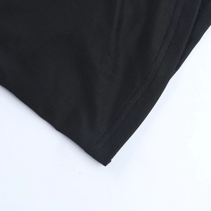 Close-up of black lace dress detailing exquisite stitching and mesh fabric texture