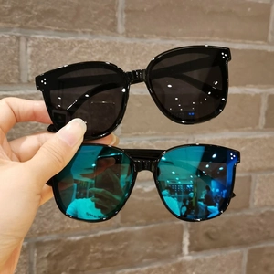 Detail shot of large frame sunglasses with iconic triple dot metal rivets and mirrored lenses