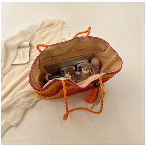Top view of large straw beach tote bag showing spacious interior with personal items