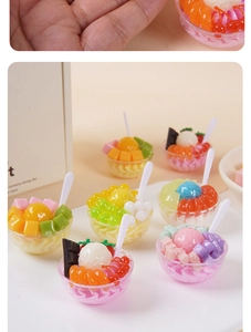 Macro shot of miniature fruit dessert bowls on fingertips showing detailed resin textures