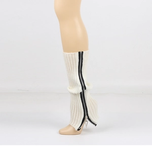 Close-up of cream knit leg warmer featuring a black zipper with metal triangle pendant