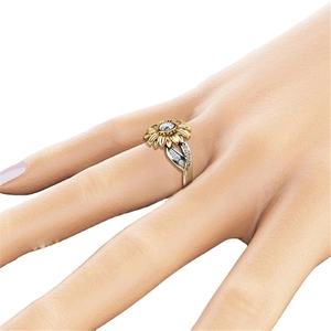 Two-tone sunflower ring with 18k gold petals and silver band worn on hand