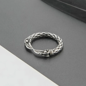 Retro punk eagle beak ring in silver with dragon scale texture and bold masculine design