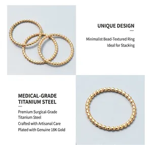Detail of minimalist 18K gold plated titanium steel beaded rings with stackable design