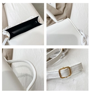 Close-up of white leather handbag featuring gold hardware and adjustable strap detail