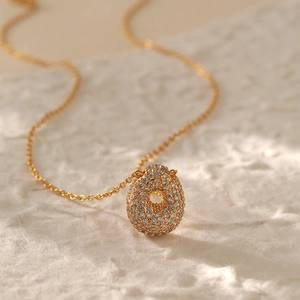 Macro shot of 26-letter necklace featuring drop pendant pavé-set with sparkling zircons