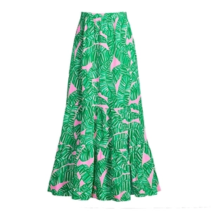 Detail of high-waist skirt with vibrant tropical green banana leaf print on pink fabric