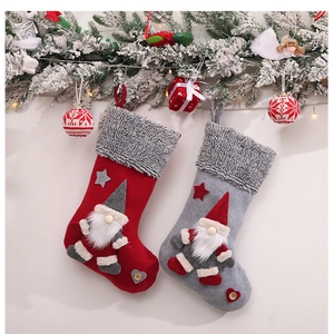 Detail of red and grey Christmas stockings with gnome doll ornaments and star accents