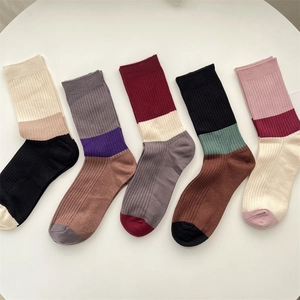 Detail of five pairs of warm cashmere socks with colorful contrast stripe rib patterns
