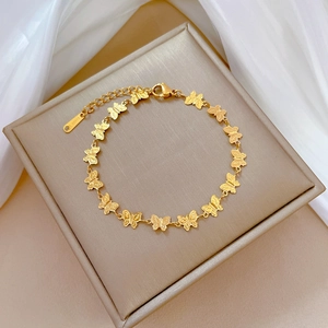 Golden titanium steel butterfly bracelet with embossed texture on jewelry box