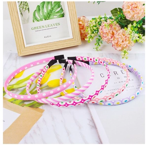 Flat lay of colorful floral and polka dot fabric headbands on a marble surface